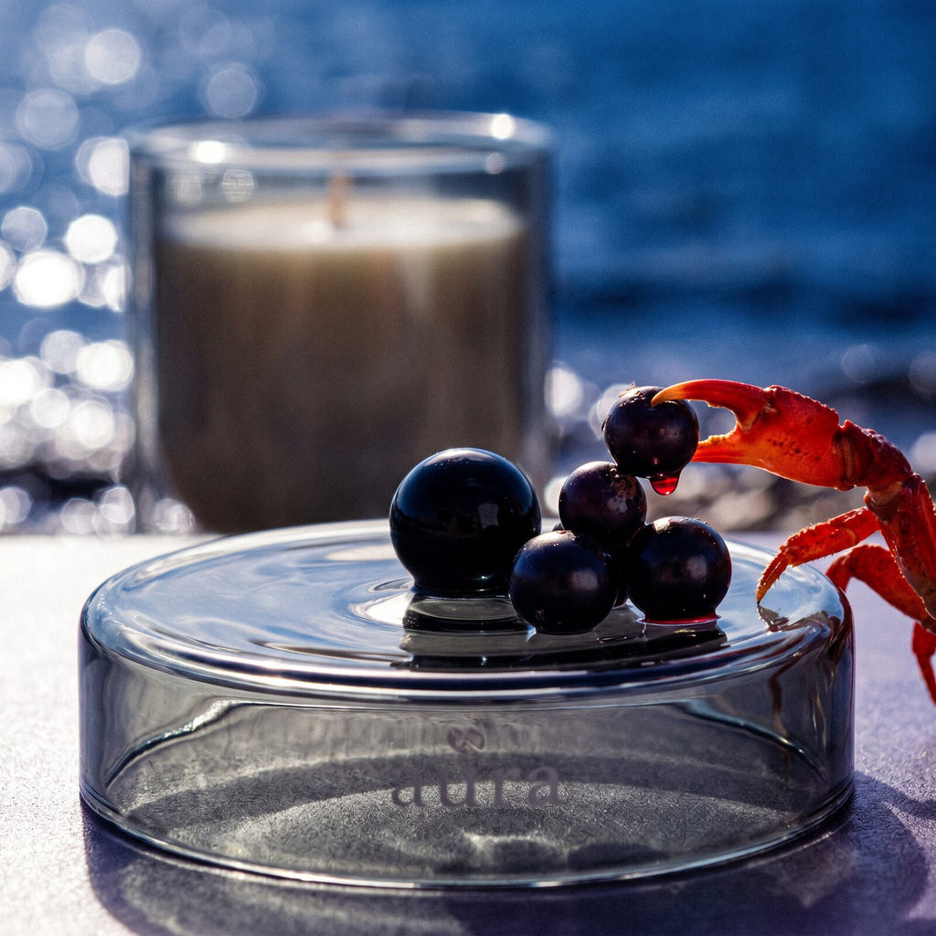 Cassis scented candle lit — warm editorial still life